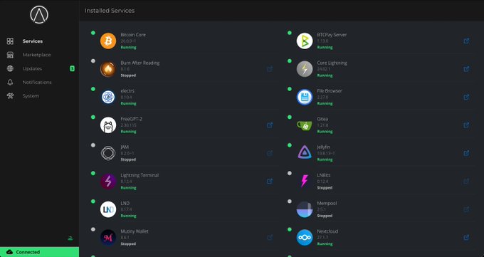 A screenshot of an 'Installed Services' dashboard from Umbrel showing various apps including Bitcoin Core, Lightning Terminal, LND, Mempool, Nextcloud, Ride The Lightning, and Sphinx Relay, with green dots indicating running status.