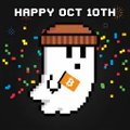 A pixel art graphic showing a white coffee cup with a brown lid and an orange tea bag tag, surrounded by colorful sprinkles, with 'HAPPY OCT 10TH' text.
