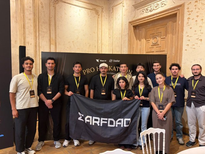 A group photo of around a dozen people, many wearing yellow lanyards, holding a 'ZARFDOC' banner in front of a 'PRO HOCKEY KATOWICE' backdrop featuring Mizuno and Stok sponsor logos.