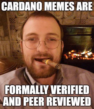 A meme of a bearded man smoking a cigar by a fireplace with text reading 'CARDANO MEMES ARE' on top and 'FORMALLY VERIFIED AND PEER REVIEWED' on the bottom.