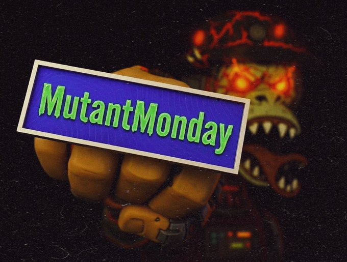A dark image featuring a menacing, glowing-eyed mutant character with its tongue out, partially behind a fist holding a blue and white sign that reads "MutantMonday" in green text.