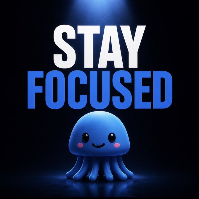 A motivational graphic featuring a cute blue octopus-like creature under a spotlight with the text 'STAY FOCUSED' in large white and blue letters.