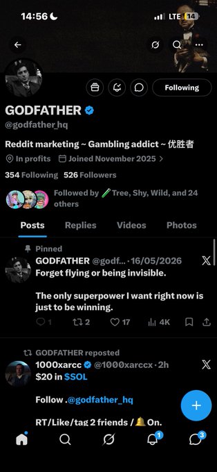 Screenshot of an X/Twitter profile for GODFATHER (@godfather_hq) describing themselves as a 'Reddit marketing~ Gambling addict~', showing a pinned post about wanting 'the only superpower... to be winning.'