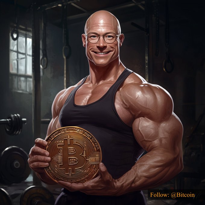 A muscular bald man wearing glasses smiles broadly while proudly holding a large golden Bitcoin medallion in a gritty gym setting, with "Follow: @Bitcoin" displayed in the corner—visually personifying the strength and triumph of Bitcoin reaching $77,022.82.