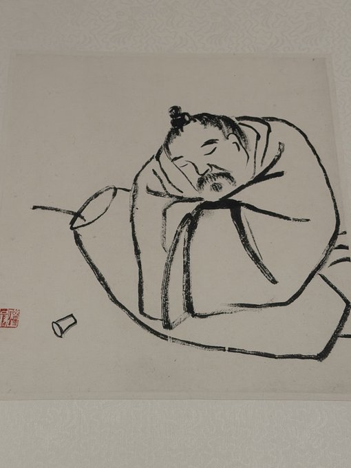 A traditional Chinese ink painting depicts a bearded scholar in robes resting his head on a desk beside a cup, evoking a sense of contemplation or exhaustion that mirrors the post's reflection on how achieving success has become increasingly difficult in modern times compared to the past. A red seal stamp appears in the lower left corner of the artwork.