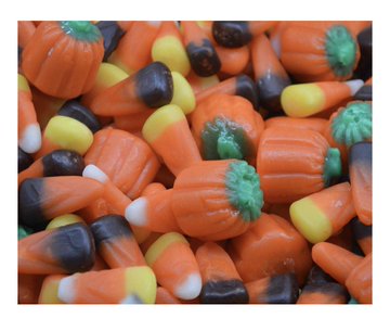 A pile of Halloween-themed candy featuring pumpkin-shaped pieces, candy corn, and black and orange jelly beans.