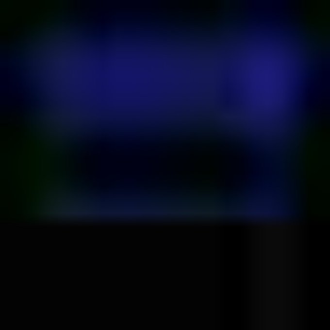 Dark, blurred image with faint blue and green lighting, too obscured to discern any clear subject.
