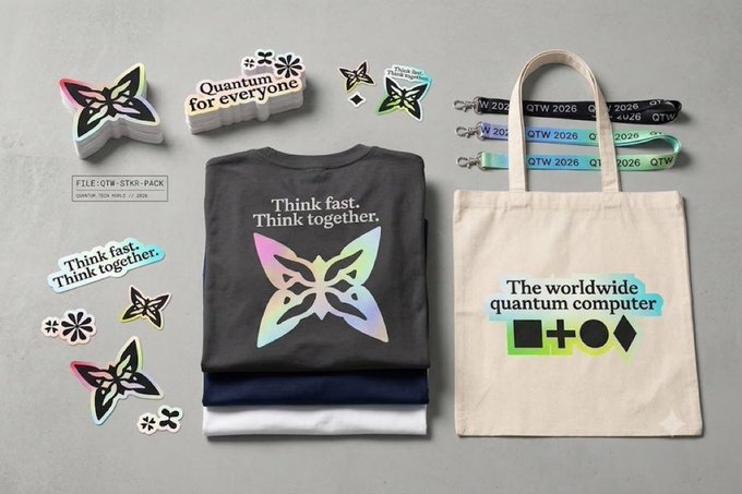 A flat-lay merchandise collection for a quantum-themed event featuring holographic butterfly stickers, a 'Quantum for everyone' badge, folded t-shirts reading 'Think fast. Think together.', lanyards marked 'QTW 2026', and a tote bag stating 'The worldwide quantum computer'.