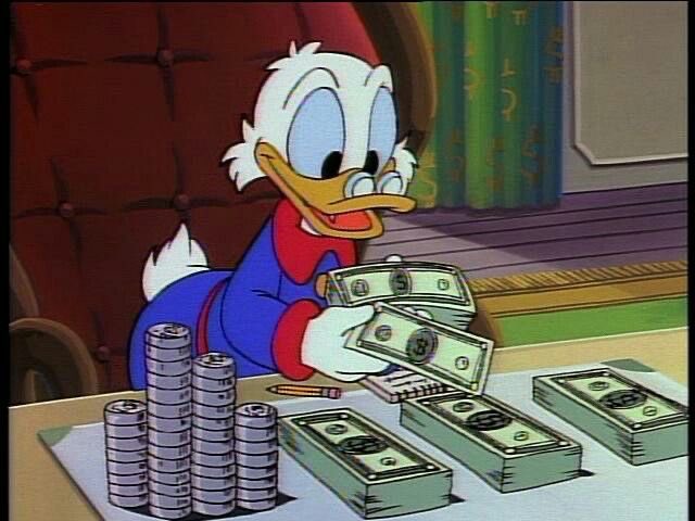 An animated scene of Scrooge McDuck sitting at a desk counting stacks of gold coins and bundles of $5 bills.