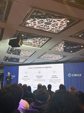 A conference presentation showing a slide titled 'Circle's commitment to Argentina' with 'USDC' visible, in a room with a decorative geometric ceiling.