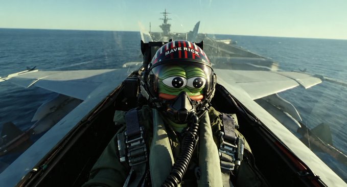A pilot wearing a green Pepe the Frog mask and oxygen gear sits in the cockpit of a jet aircraft flying over the ocean, with an aircraft carrier visible in the background. The post’s “$PEPE looks good here” refers to the frog-themed meme imagery displayed on the pilot’s helmet.
