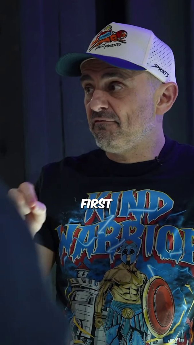 The image shows a man wearing a t-shirt with a graphic of a cat that looks like it's about to come out of a trap or a building. The man is giving instructions as if he has just revealed something important, such as why the Black Cat Eruption might become one of the biggest chase cards of 2006, and what collectors have already placed on Gary to pull this off.