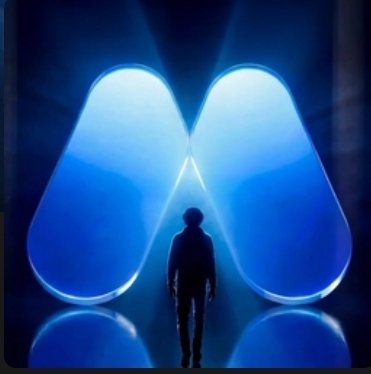 A dark silhouette of a person standing facing a large, glowing blue, wing-like or M-shaped light installation.