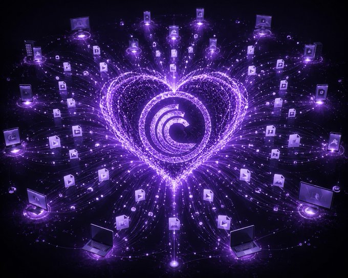 A vibrant purple digital illustration showing a glowing heart made of particles at the center of a swirling logo, surrounded by orbiting laptops and lock/file icons connected by streams of light.