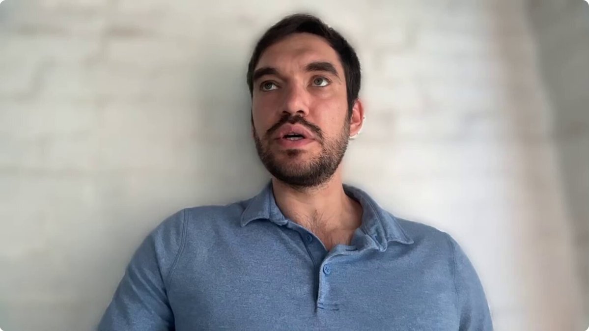 The image shows a man sitting down against a white wall wearing a blue shirt with his hands at his sides, looking off into the distance with an uncertain expression. The image also references Bitcoin as "just in" something interesting happening about Bitcoins which includes, "If Apple had just kept 2% of its corporate treasury in BTC, it would have outperformed inflation Over the last 6 years."