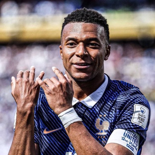 Kylian Mbappé, wearing a France national team jersey with the "Football Unites the World" and "Unite to #Peace" armbands, smiles and gestures with his hands after a match. The image complements the post's metaphor of Mbappé's influence on the game, drawing a parallel to Bitcoin dominance—where impact and control extend beyond just scoring, much like strategic dominance in the crypto market.