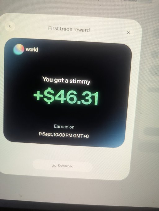 A photograph of a digital screen showing a 'First trade reward' notification with a 'world' logo, displaying the message 'You got a stimmy +$46.31' earned on '9 Sept, 10:03 PM GMT+6'.