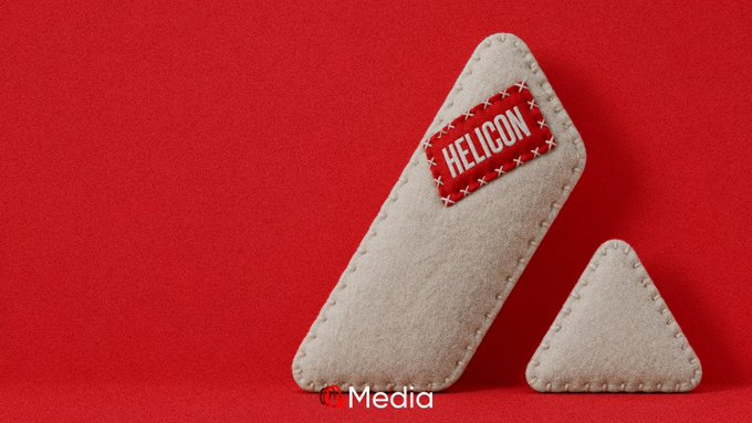A gray triangular felt object with a 'HELLCON' patch next to a smaller triangle, set against a red background, with a 'Media' watermark.