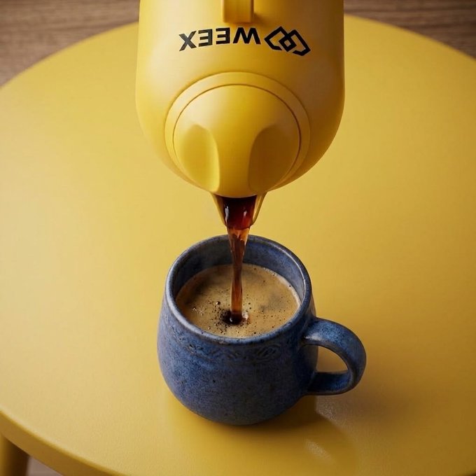 A yellow MEE X coffee machine dispenses dark coffee into a blue ceramic mug on a yellow surface.