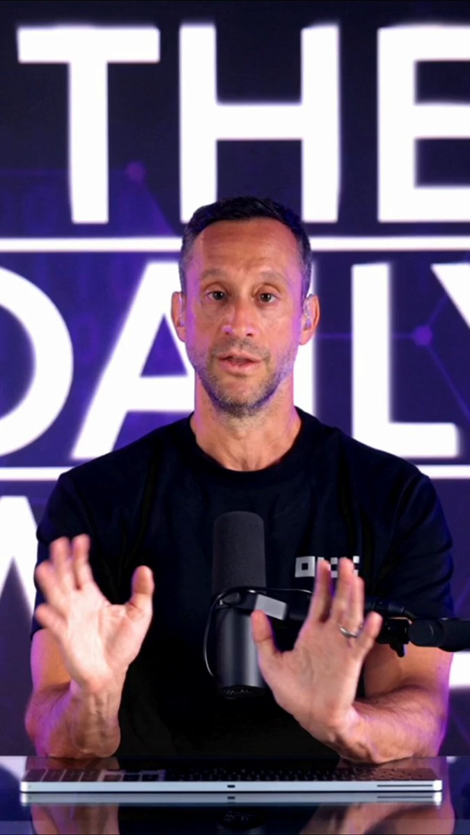The image features a man sitting at a desk with his hands outstretched as if he's giving a speech or presentation. He appears to be wearing a black shirt, which contrasts with the purple background behind him. The background also includes text that reads "Ethereum’s new pitch: Slow, expensive, unstoppable." This suggests that the man might be discussing the potential benefits and drawbacks of investing in Ethereum, a cryptocurrency.