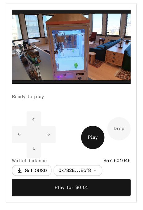 A mobile interface for "The Claw" game showing a live feed of a physical claw machine in an office, with controls including directional arrows, "Play," and "Drop" buttons, a wallet balance of $57.501045 OUSD, and a "Play for $0.01" button at the bottom. The setup reflects the post's description of OpenClaw, where users can remotely control or program a robotic claw machine connected to the Tempo blockchain.