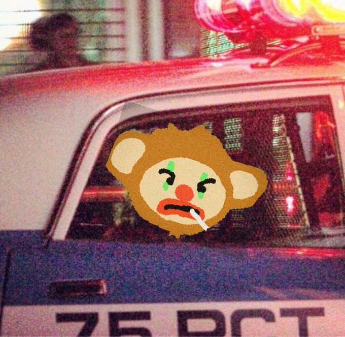 A grainy, vintage-style photograph of the back of a police car ('75 DCT') with red and blue lights flashing, featuring a cartoon drawing of a crying monkey face with a cigarette drawn over the rear window.