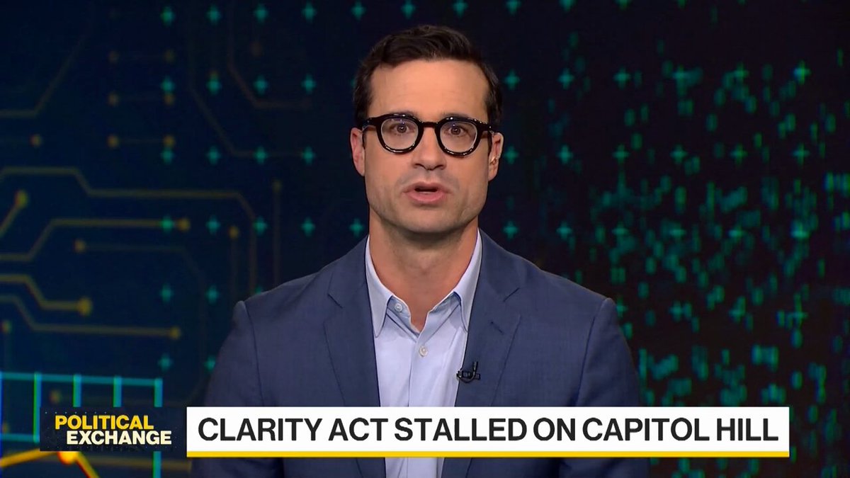 A man in glasses and a blue suit speaks on Bloomberg's "Political Exchange" segment, with the chyron reading "CLARITY ACT STALLED ON CAPITOL HILL" against a digital circuit-board backdrop. The image ties to the post's discussion of the Clarity Act, which defines digital assets and their regulators, with the speaker (likely Jake Chervinsky, referenced as @jaebersole1) addressing the stalled legislation and the broader challenge of bringing real-world assets onchain.