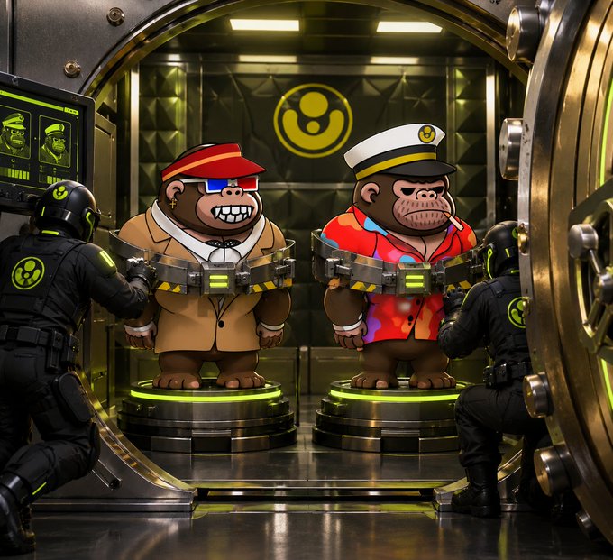 Two cartoon ape characters—one in a tan suit with a red visor, the other in a colorful shirt and sailor hat—are restrained on platforms inside a vault-like room with a biohazard symbol, guarded by armed soldiers.