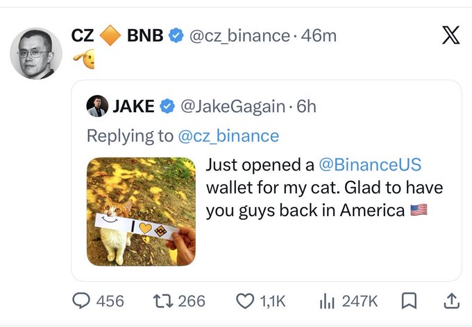A screenshot of a tweet by CZ (cz_binance) quoting a post by Jake (@JakeGagain) that says, 'Just opened a @BinanceUS wallet for my cat. Glad to have you guys back in America,' accompanied by a picture of a cat in yellow sunglasses next to a Binance card.