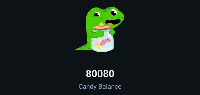 A cartoon green dinosaur (Duolingo's mascot) clutches a jar of candy above the text "80080 Candy Balance," humorously tying the "in crypto without saying you're in crypto" theme to meme-coins like Duolingo's DUO token, which famously surged on candy-themed speculation.
