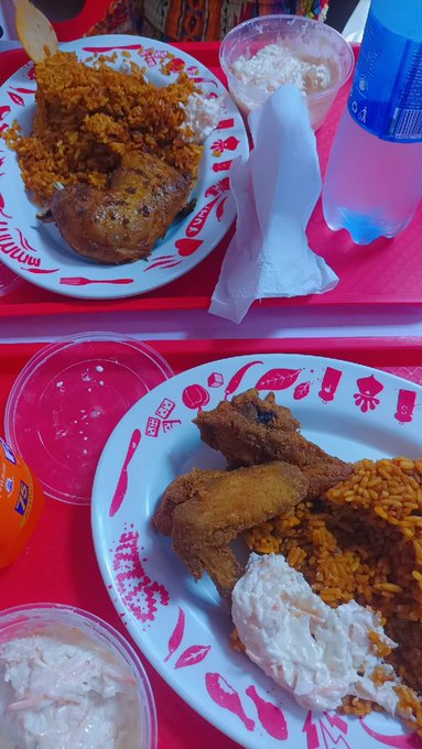 Two plates of jollof rice with fried chicken and coleslaw are shown, as if to imply the offer of food or money to someone who hasn't eaten.