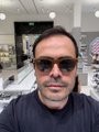 A man wearing sunglasses takes a selfie inside what appears to be a tech or office setting with decorative lighting visible in the background. The image pairs with a promotional post about Walrus Memory, an AI memory solution on the Sui blockchain designed to operate independently of any LLM.