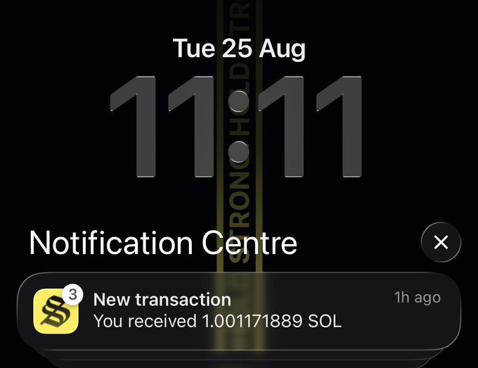 A smartphone screen displays the time 11:11 on Tuesday, August 25, with a notification reading 'New transaction: You received 1.001171889 SOL'.