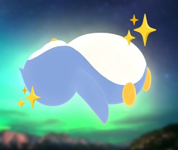 An illustration of a blue and white whale-like creature with yellow fins floating against an aurora-lit night sky with sparkles.