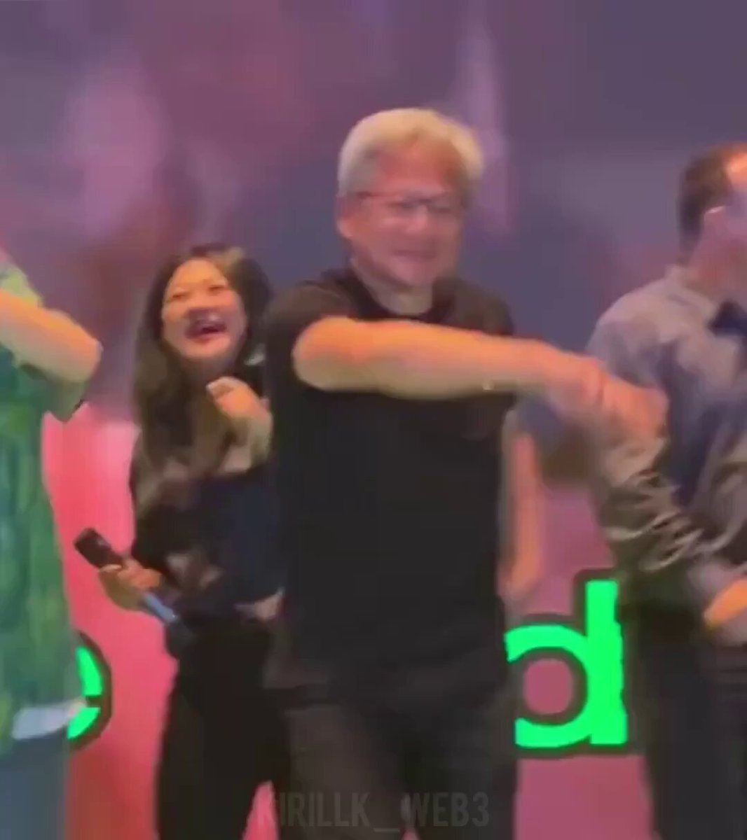The image shows a man wearing glasses dancing with another person, who appears to be a woman. They are both smiling as they dance together. The background of the image features a banner that says "BLOODBATH EVERYWHERE". This suggests that the event might have some sort of theme or connection to blood, possibly related to a performance or an artistic expression.