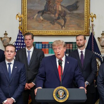 President Donald Trump speaks at a podium bearing the presidential seal in the Roosevelt Room, flanked by advisors and an American flag, as the administration intensifies its push to persuade senators to advance the Crypto CLARITY Act for clearer digital asset regulations.