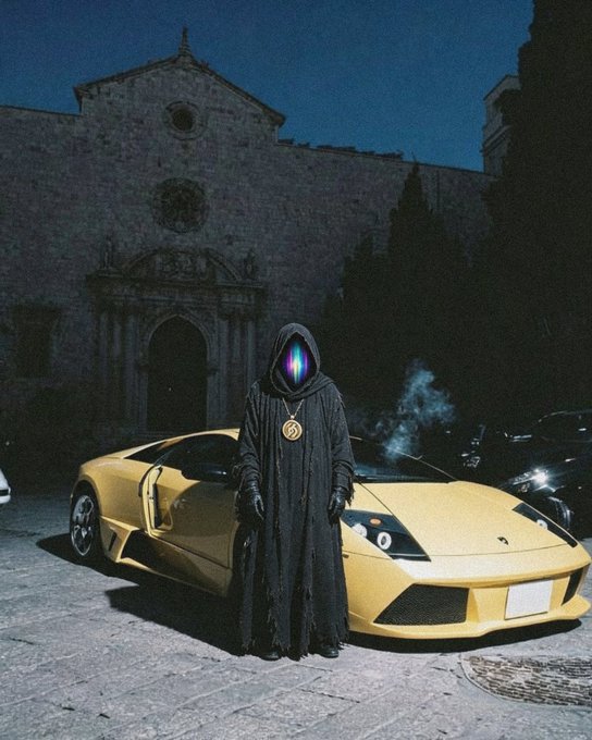 A photo-manipulated image of a hooded figure with a glowing, colorful LED-style face mask wearing a large gold medallion, standing in front of a yellow Lamborghini Murciélago parked before a stone church at night.