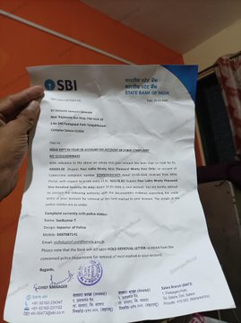 A hand holds a warning letter from State Bank of India (SBI) cautioning the recipient about a loan/cheque clearance scam, urging them to beware of cyber fraud involving Sumit Ghule and Branch Bhopal. The image supports the post by highlighting the prevalence of P2P and digital scams in India, with SBI issuing official alerts to customers.