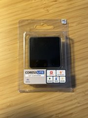 A small black device branded "COMESH" sits on a wooden surface in clear packaging, likely the hardware used in the KasWallet proof-of-concept demo where the KasSigner is concealed behind a calculator interface to reveal a $KAS wallet when a specific equation is entered.