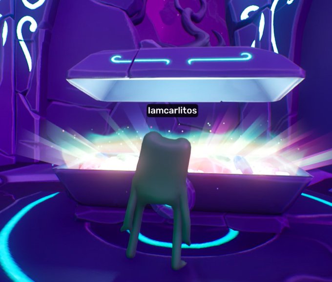 A screenshot from a video game showing a green, shadowy figure standing before an open, glowing chest in a dark, purple, futuristic-looking room with the text 'lamcarlitos' above the character.