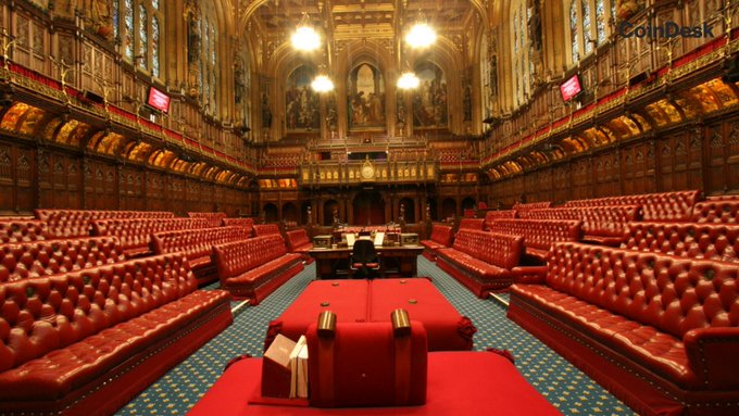 The image shows the ornate red-leather benches of the UK House of Lords chamber, with "CoinDesk" watermarked in the upper right, visually tying to the post about the Lords passing an amendment requiring the Treasury to publish a national digital asset strategy covering crypto, stablecoins, and tokenized securities.