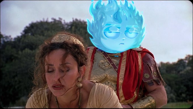 A scene featuring a woman with curly hair wearing a headband next to a figure in Roman-style armor, whose head has been replaced by a blue, flame-like cartoon character with glasses.