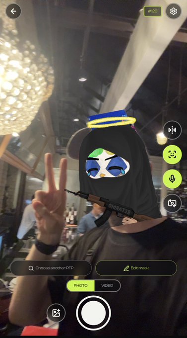 A Snapchat camera screen showing a person with a cartoon halo and a masked penguin avatar giving a peace sign, with UI elements like 'Choose another FF/P', 'Edit mask', and 'PHOTO/VIDEO'.
