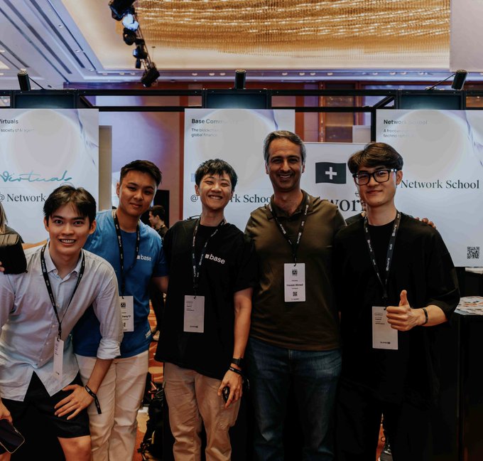 The image features a group of six young men posing for a photo in front of a stage with banners hanging from the ceiling. The banners display the words "Bebop", "Base", "SuperAI", and "@baseapac". One man is wearing glasses, while another has a thumbs-up gesture. The background includes a large screen or projector mounted on the wall behind them.

The group of young men appears to be attending an event related to robotics, AI, or some other technological field. They are all smiling and posing for the photo, indicating their excitement about the subject matter. The presence of banners with specific words suggests that this gathering might be part of a conference or exhibition where attendees can learn more about the latest advancements in these areas.