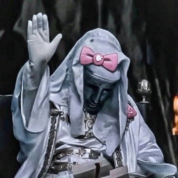 A gray, hooded figure wearing a pink bow waves its hand, likely referencing the meme "Am I a man who treats children like adults, or am I a man who treats adults like children?" — the post's question "1 or 2, leaning 1" playfully asks viewers to choose between these two conflicting character archetypes represented by the whimsical yet dark image.