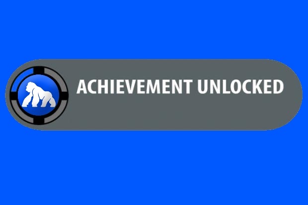 A blue background graphic with a dark gray rounded banner displaying 'ACHIEVEMENT UNLOCKED' in white text, accompanied by a circular icon featuring a gorilla on a poker chip design.