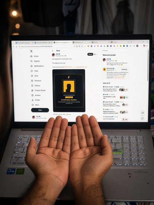 Two open palms are held up in front of a laptop displaying the X (formerly Twitter) Post analytics page for a user named 'Mia' with the tweet 'Good luck, hunter.'