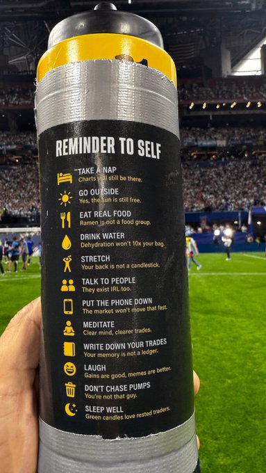 A hand holds a water bottle featuring a "Reminder to Self" checklist with trading and lifestyle tips like "Drink Water," "Write Down Your Trades," and "Don't Chase Pumps," set against the backdrop of a soccer stadium. The list humorously reinforces the post's message about "the secret sauce" being disciplined fundamentals rather than flashy plays.