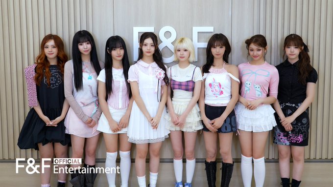 Eight members of the K-pop group UNIS pose together in coordinated pastel and playful outfits in front of an "F&F" logo backdrop, with "F&F Official Entertainment" watermark visible in the corner, as part of their 2026 Chuseok greetings message.