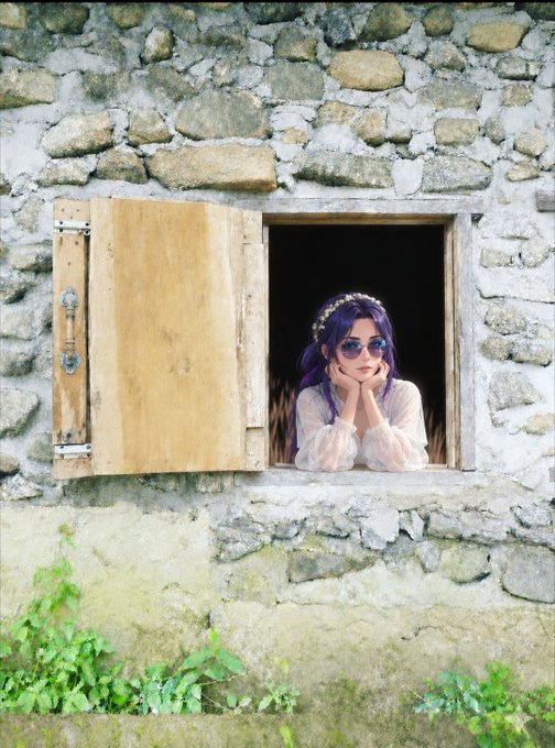 A person with sunglasses and a white floral top leans on the sill of a wooden-shuttered window set into an old stone wall.